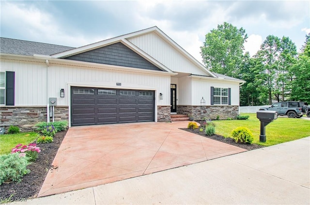 993 Pin Oaks Dr, Broadview Heights, OH 44147 - view of front of property with stone siding, a garage, a front yard, and concrete driveway