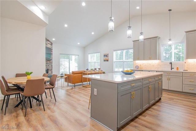 993 Pin Oaks Dr, Broadview Heights, OH 44147 - kitchen featuring gray cabinets, high vaulted ceiling, healthy amount of natural light, a kitchen island, and recessed lighting