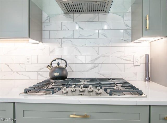 993 Pin Oaks Dr, Broadview Heights, OH 44147 - kitchen featuring exhaust hood, stainless steel gas cooktop, light countertops, decorative backsplash, and gray cabinets