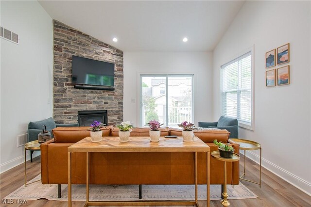 993 Pin Oaks Dr, Broadview Heights, OH 44147 - living room with a stone fireplace, wood finished floors, and lofted ceiling