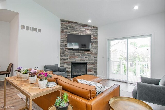 993 Pin Oaks Dr, Broadview Heights, OH 44147 - living room with wood finished floors, lofted ceiling, and a fireplace