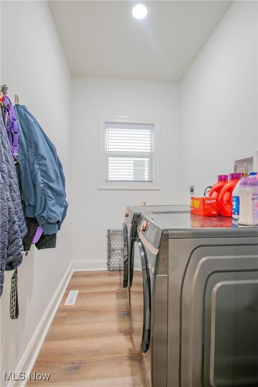993 Pin Oaks Dr, Broadview Heights, OH 44147 - laundry room with washer and dryer and light wood-type flooring
