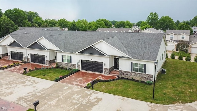 993 Pin Oaks Dr, Broadview Heights, OH 44147 - modern inspired farmhouse with stone siding, a front yard, and a shingled roof