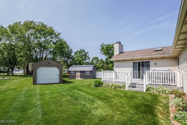 1769 Clearbrook Rd NW, Massillon, OH 44646 - view of grassy yard featuring a deck and a storage shed