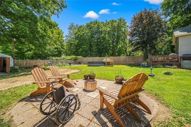 6086 N Wright St, Kingsville, OH 44048 - fenced backyard with a fire pit, a patio area, and a wooden deck