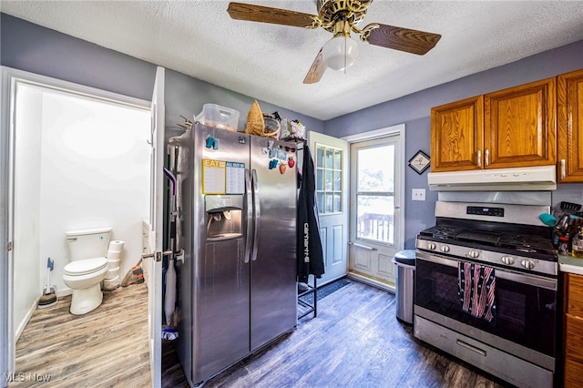 6086 N Wright St, Kingsville, OH 44048 - kitchen featuring stainless steel appliances, under cabinet range hood, wood finished floors, brown cabinetry, and ceiling fan