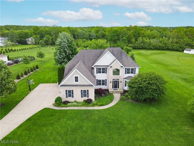 7305 Alexander Rd, Concord, OH 44077 - view of front of property with a front lawn, a wooded view, and concrete driveway