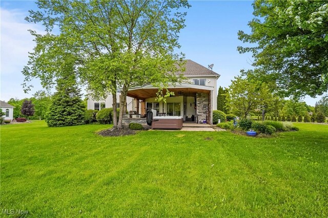 7305 Alexander Rd, Concord, OH 44077 - back of house featuring a yard, stone siding, and a patio area