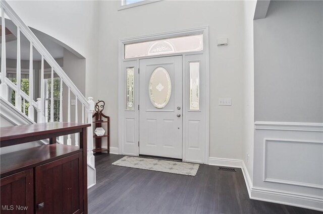 7305 Alexander Rd, Concord, OH 44077 - entryway with dark wood-style floors, stairs, and arched walkways
