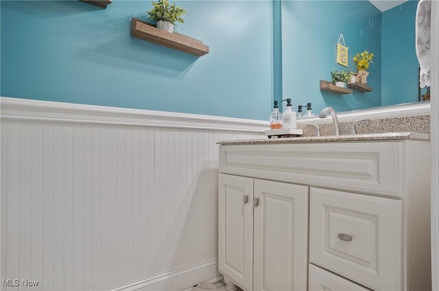 7305 Alexander Rd, Concord, OH 44077 - bathroom featuring vanity and wainscoting
