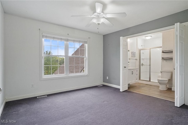 7305 Alexander Rd, Concord, OH 44077 - unfurnished bedroom with dark carpet, ensuite bathroom, and a ceiling fan
