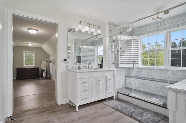 7305 Alexander Rd, Concord, OH 44077 - bathroom with vanity, a stall shower, wood finished floors, and lofted ceiling