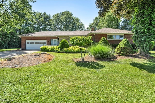 4928 Lane Rd, Perry, OH 44081 - ranch-style home featuring brick siding, asphalt driveway, a garage, and a front lawn