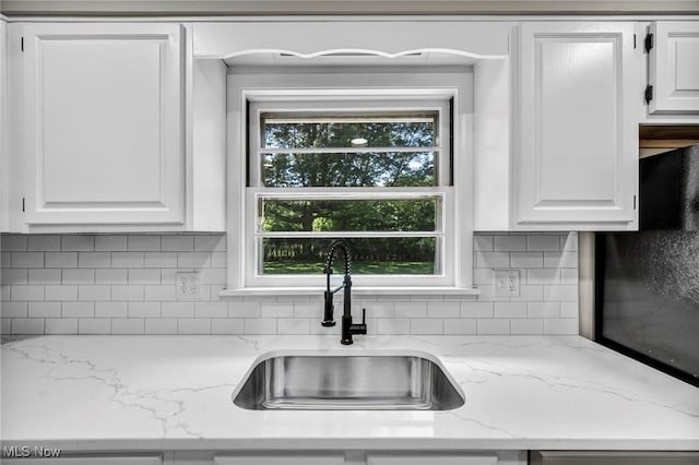4928 Lane Rd, Perry, OH 44081 - kitchen with white cabinetry, backsplash, and light stone counters