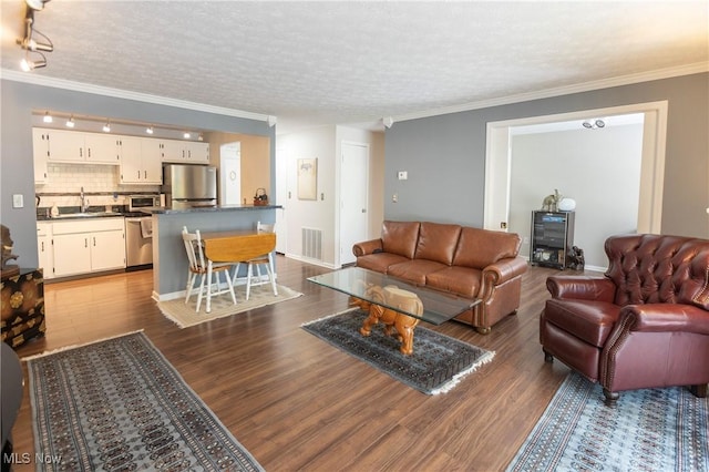 2021 King James Pkwy Unit 214, Westlake, OH 44145 - living area with dark wood finished floors, ornamental molding, a textured ceiling, and track lighting