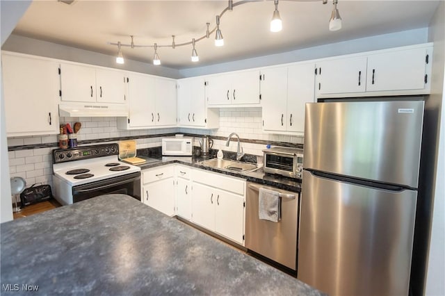 2021 King James Pkwy Unit 214, Westlake, OH 44145 - kitchen featuring stainless steel appliances, dark countertops, white cabinets, and under cabinet range hood