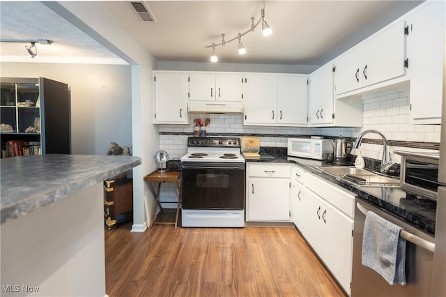 2021 King James Pkwy Unit 214, Westlake, OH 44145 - kitchen with white appliances, under cabinet range hood, dark countertops, light wood-style floors, and backsplash