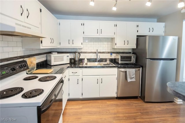 2021 King James Pkwy Unit 214, Westlake, OH 44145 - kitchen with appliances with stainless steel finishes, under cabinet range hood, white cabinetry, and tasteful backsplash