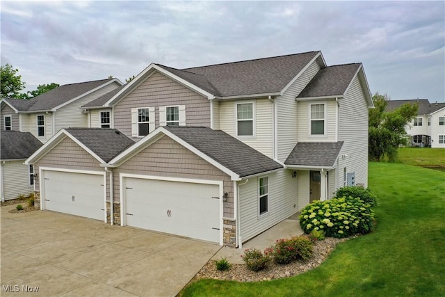 1315 Cascade Cir E, Canton, OH 44708 - view of front of house with an attached garage, concrete driveway, a front lawn, and a shingled roof