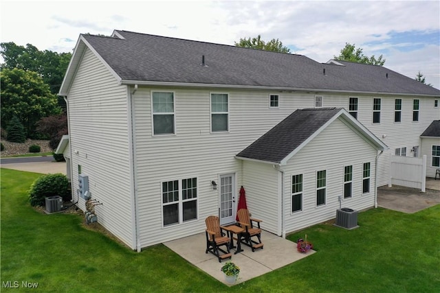 1315 Cascade Cir E, Canton, OH 44708 - rear view of property featuring a patio, a yard, and a shingled roof