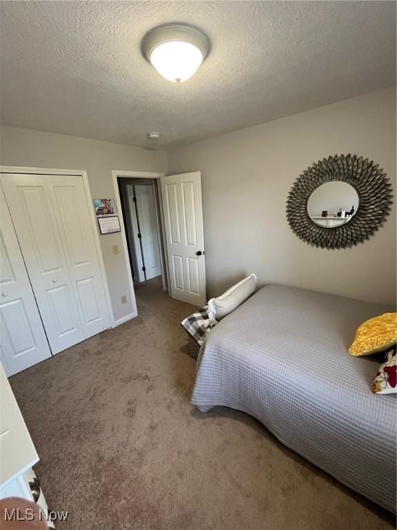 1315 Cascade Cir E, Canton, OH 44708 - carpeted bedroom with a closet and a textured ceiling