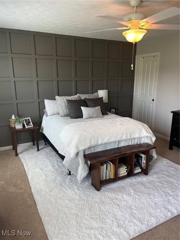 1315 Cascade Cir E, Canton, OH 44708 - carpeted bedroom featuring a decorative wall and ceiling fan