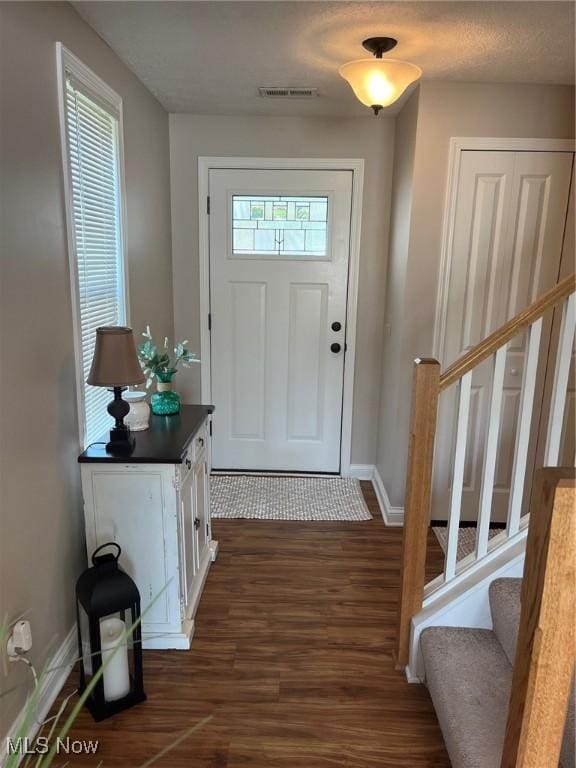 1315 Cascade Cir E, Canton, OH 44708 - foyer featuring dark wood-type flooring and stairway