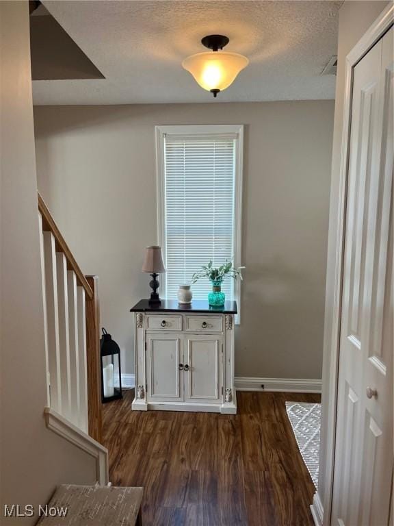 1315 Cascade Cir E, Canton, OH 44708 - foyer with dark wood finished floors, stairs, and a textured ceiling