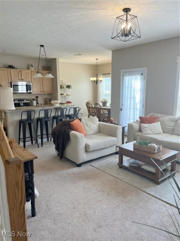 1315 Cascade Cir E, Canton, OH 44708 - living area featuring a chandelier and light carpet