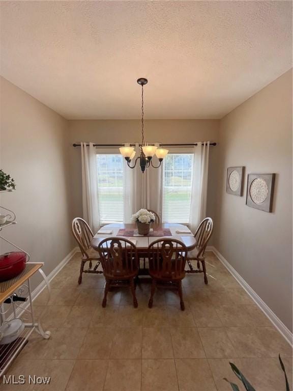 1315 Cascade Cir E, Canton, OH 44708 - dining space with plenty of natural light, light tile patterned floors, a textured ceiling, and a chandelier