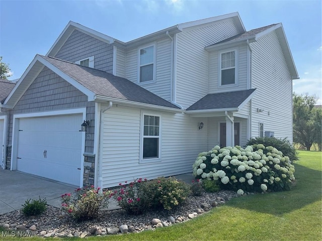 1315 Cascade Cir E, Canton, OH 44708 - view of front of house with an attached garage, concrete driveway, a shingled roof, and a front yard
