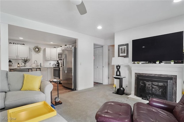 47688 Tomahawk Dr, Negley, OH 44441 - living area featuring light colored carpet, a ceiling fan, recessed lighting, and a high end fireplace