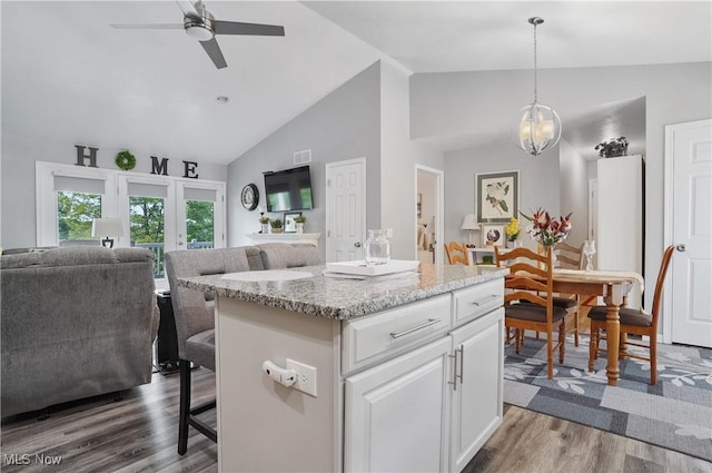 47688 Tomahawk Dr, Negley, OH 44441 - kitchen featuring open floor plan, a kitchen breakfast bar, white cabinetry, dark wood-style floors, and a kitchen island