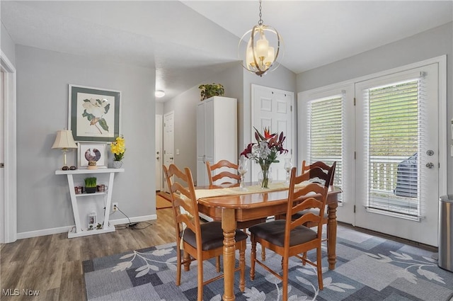 47688 Tomahawk Dr, Negley, OH 44441 - dining area featuring lofted ceiling, wood finished floors, and a chandelier