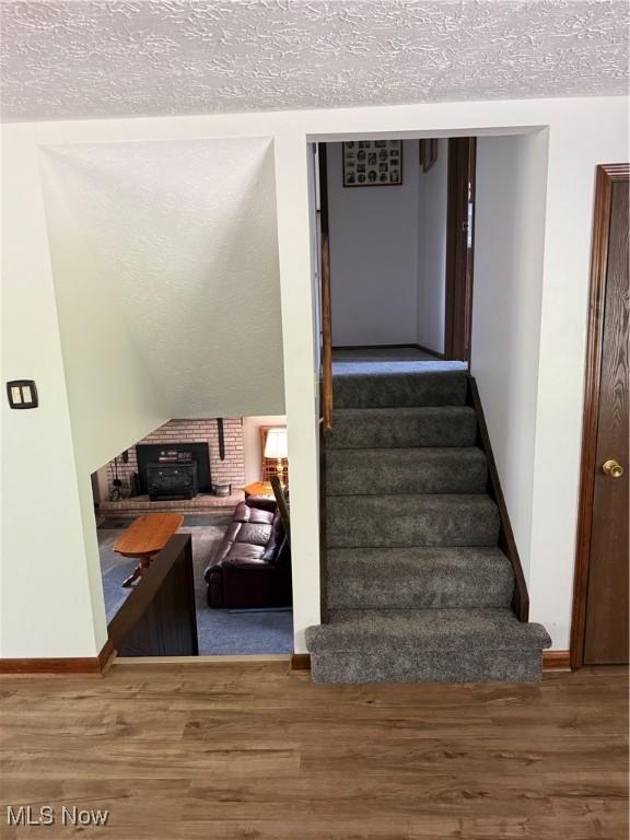11778 Sharp Dr, Doylestown, OH 44230 - stairs with wood finished floors and a textured ceiling