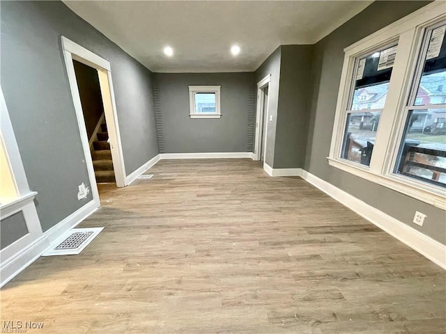 10003 Empire Ave, Cleveland, OH 44108 - spare room featuring wood finished floors, stairway, and recessed lighting