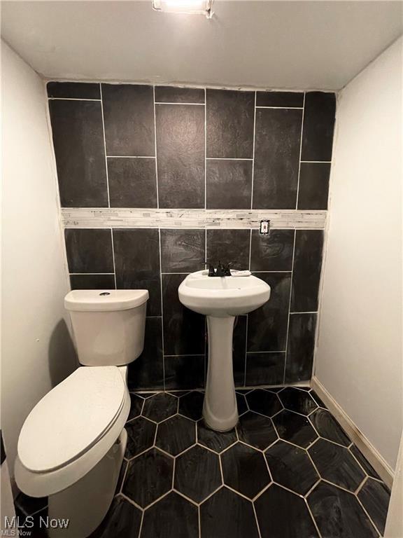 10003 Empire Ave, Cleveland, OH 44108 - bathroom featuring tile patterned flooring and tile walls