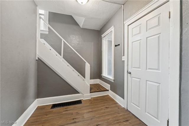 4002 Ardmore Ave, Cleveland, OH 44109 - entrance foyer with stairway, wood finished floors, and a textured ceiling