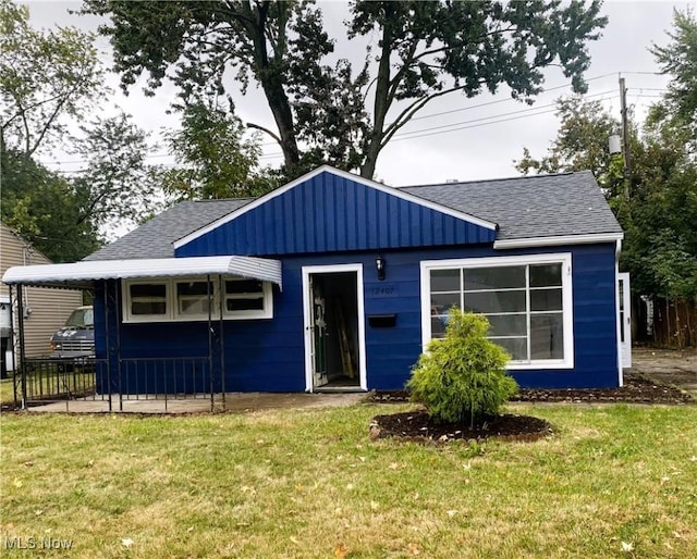 12407 Summerland Ave, Cleveland, OH 44111 - view of front facade featuring roof with shingles and a front yard