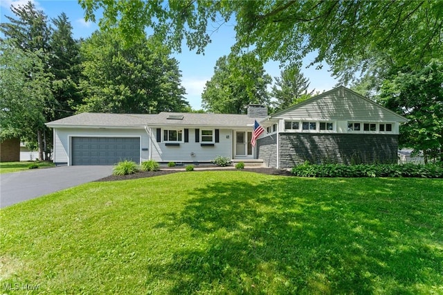 70 Maple St, Canfield, OH 44406 - view of front of house featuring driveway, a garage, a front lawn, and a chimney