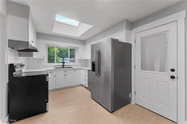 70 Maple St, Canfield, OH 44406 - kitchen featuring high end fridge, electric range, a skylight, exhaust hood, and light wood finished floors