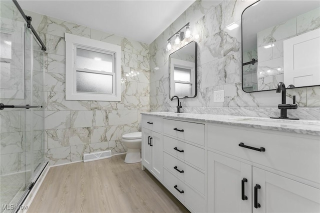 70 Maple St, Canfield, OH 44406 - bathroom with a baseboard radiator, tile walls, a marble finish shower, double vanity, and plenty of natural light