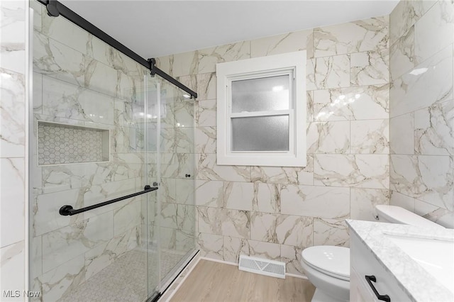 70 Maple St, Canfield, OH 44406 - bathroom featuring a shower stall, vanity, wood finished floors, and tile walls
