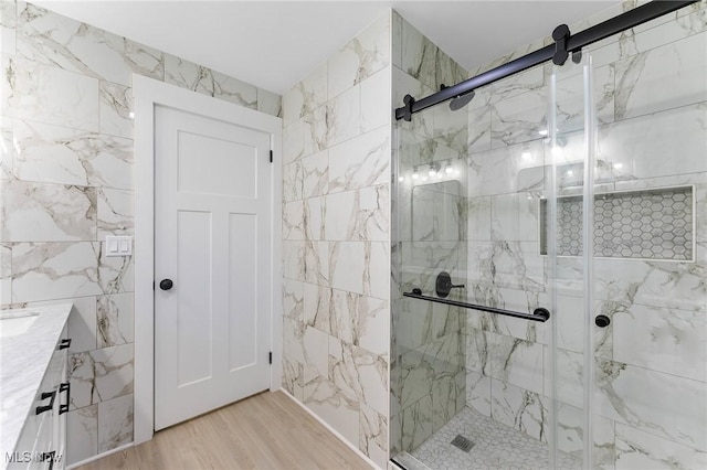 70 Maple St, Canfield, OH 44406 - bathroom with a marble finish shower, tile walls, vanity, and wood finished floors