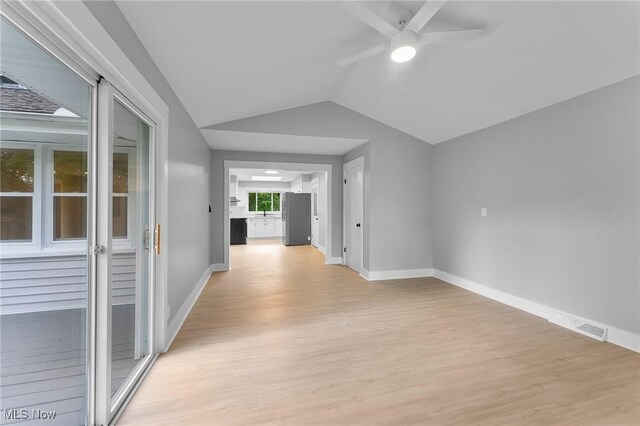 70 Maple St, Canfield, OH 44406 - empty room featuring a ceiling fan, light wood-style floors, and vaulted ceiling
