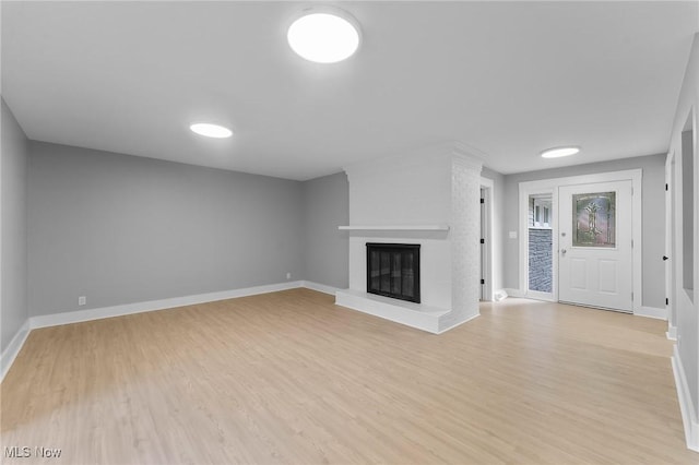 70 Maple St, Canfield, OH 44406 - unfurnished living room featuring light wood-style floors and a fireplace