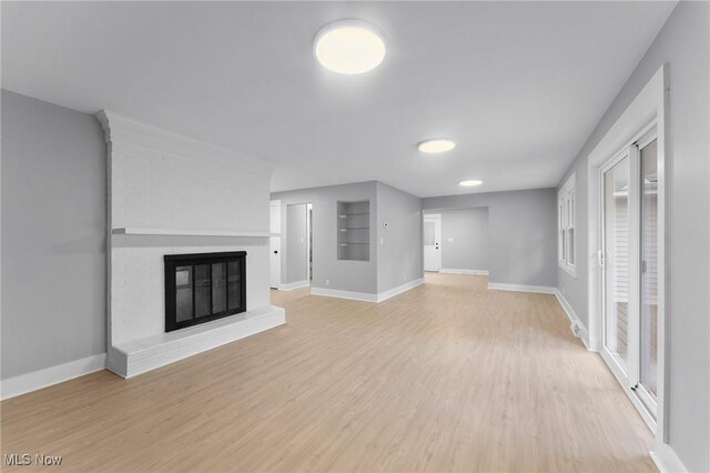 70 Maple St, Canfield, OH 44406 - unfurnished living room featuring light wood finished floors and a fireplace