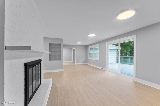 70 Maple St, Canfield, OH 44406 - unfurnished living room with a large fireplace and light wood-type flooring