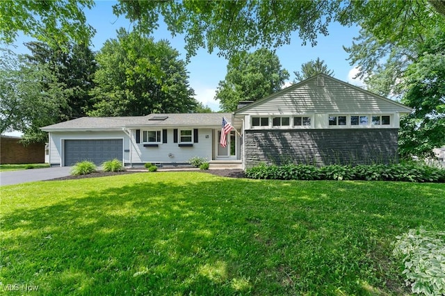 70 Maple St, Canfield, OH 44406 - ranch-style home with asphalt driveway, a garage, and a front yard