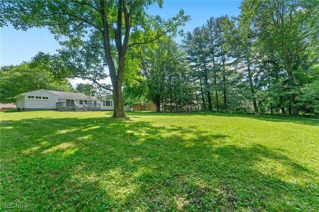 70 Maple St, Canfield, OH 44406 - view of grassy yard featuring an attached garage